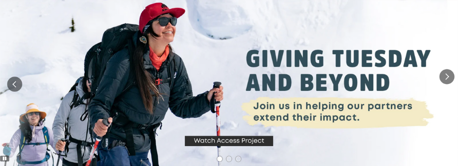 evo's Giving Tuesday banner features a smiling Indigenous woman ski touring in the backcountry.